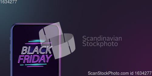 Image of Device with neon lettering, black friday, sales concept. Flyer with copyspace. Dark neoned background