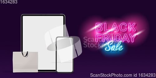 Image of Device with shopping bags, black friday, sales concept. Flyer with copyspace. Dark neoned background