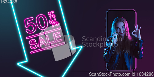 Image of Beautiful woman inviting for shopping right from device screen, black friday, sales concept. Flyer with copyspace