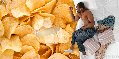 Image of Portrait of a young man sleeping and dreaming about chips