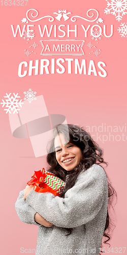 Image of Girl hugging gifts, greeting with New Year 2021 and Christmas. Flyer with copyspace
