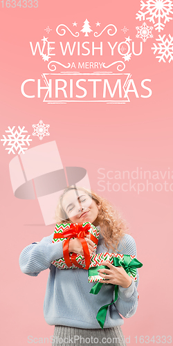 Image of Girl hugging gifts, greeting with New Year 2021 and Christmas. Flyer with copyspace