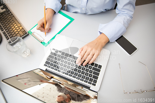 Image of Remote working from home. Workplace in home office with PC, devices and gadgets.