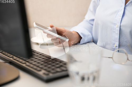 Image of Remote working from home. Workplace in home office with PC, devices and gadgets.