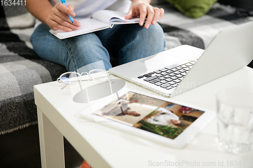 Image of Remote working from home. Workplace in home office with PC, devices and gadgets.