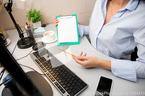 Image of Remote working from home. Workplace in home office with PC, devices and gadgets.