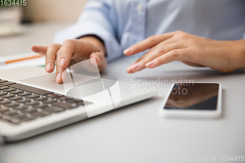 Image of Remote working from home. Workplace in home office with PC, devices and gadgets.