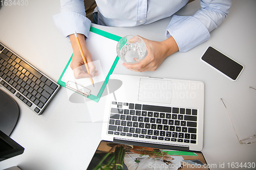 Image of Remote working from home. Workplace in home office with PC, devices and gadgets.