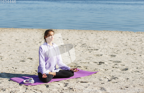 Image of Young woman training outdoors in autumn sunshine. Concept of sport, healthy lifestyle, movement, activity.