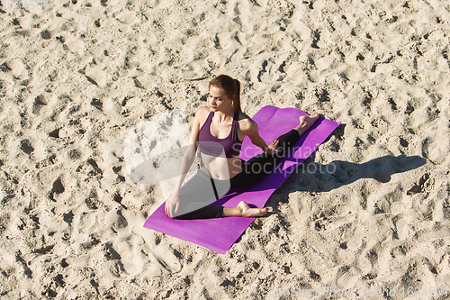 Image of Young woman training outdoors in autumn sunshine. Concept of sport, healthy lifestyle, movement, activity.