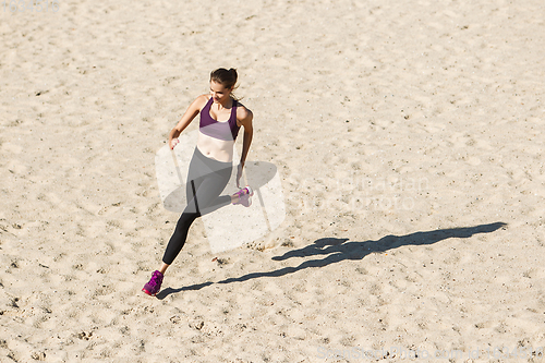 Image of Young woman training outdoors in autumn sunshine. Concept of sport, healthy lifestyle, movement, activity.