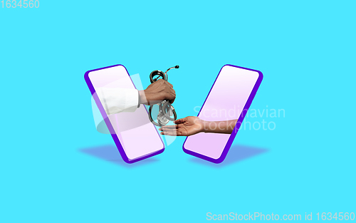 Image of Hands gesturing through screens of mobile phones against blue background. Concept of social distance during coronavirus epidemic