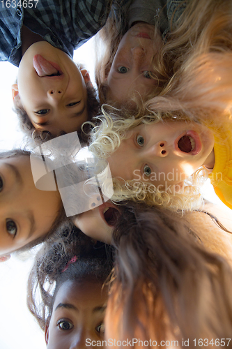 Image of Interracial group of kids, girls and boys playing together at the park in summer day