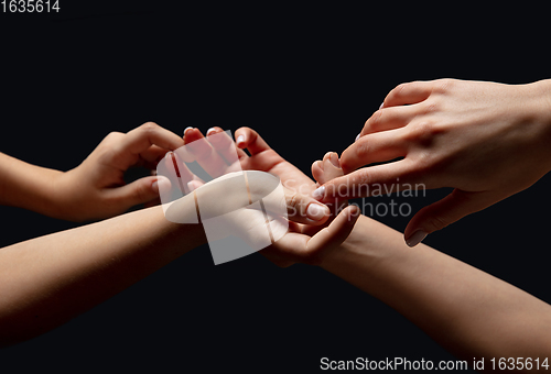 Image of Hands of people\'s crowd in touch isolated on black studio background. Concept of human relation, community, togetherness, symbolism