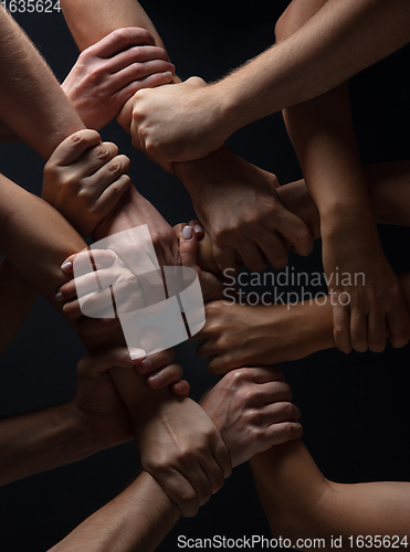 Image of Hands of people\'s crowd in touch isolated on black studio background. Concept of human relation, community, togetherness, symbolism