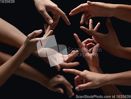 Image of Hands of people\'s crowd in touch isolated on black studio background. Concept of human relation, community, togetherness, symbolism