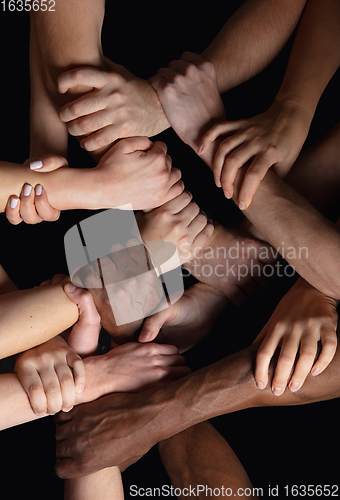 Image of Hands of people\'s crowd in touch isolated on black studio background. Concept of human relation, community, togetherness, symbolism