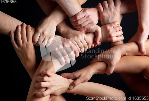 Image of Hands of people\'s crowd in touch isolated on black studio background. Concept of human relation, community, togetherness, symbolism