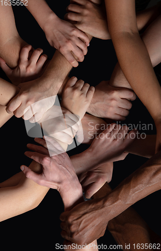 Image of Hands of people\'s crowd in touch isolated on black studio background. Concept of human relation, community, togetherness, symbolism