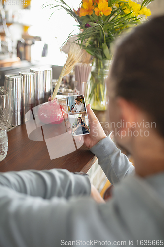 Image of Remote working. Workplace in bar, restaurant office with PC, devices and gadgets.