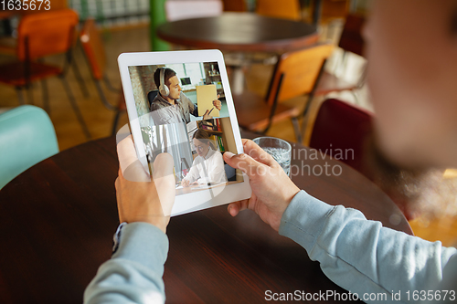 Image of Remote working. Workplace in bar, restaurant office with PC, devices and gadgets.