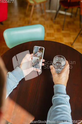 Image of Remote working. Workplace in bar, restaurant office with PC, devices and gadgets.