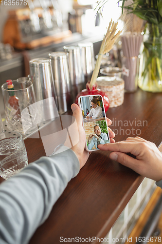 Image of Remote working. Workplace in bar, restaurant office with PC, devices and gadgets.