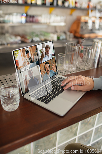 Image of Remote working. Workplace in bar, restaurant office with PC, devices and gadgets.