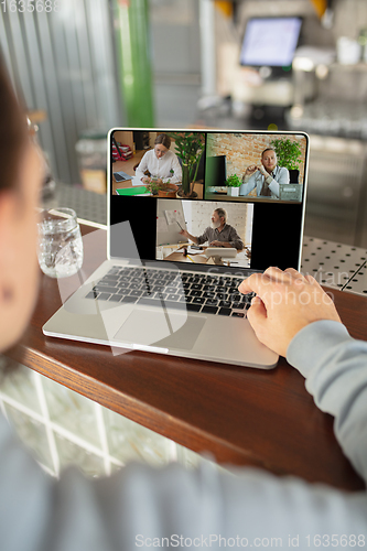 Image of Remote working. Workplace in bar, restaurant office with PC, devices and gadgets.