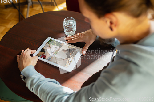 Image of Remote working. Workplace in bar, restaurant office with PC, devices and gadgets.