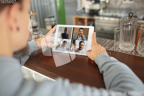 Image of Remote working. Workplace in bar, restaurant office with PC, devices and gadgets.