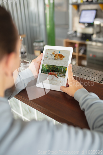 Image of Remote working. Workplace in bar, restaurant office with PC, devices and gadgets.