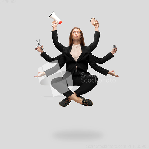 Image of Beautiful business woman, secretary, multi-armed manager levitating isolated on grey studio background