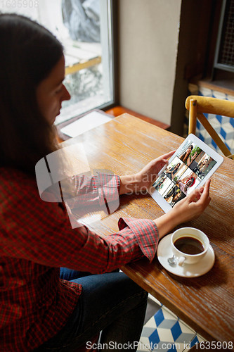 Image of Remote working. Workplace in bar, restaurant office with PC, devices and gadgets.