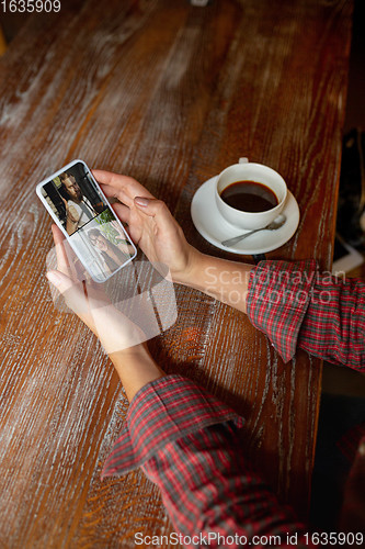 Image of Remote working. Workplace in bar, restaurant office with PC, devices and gadgets.