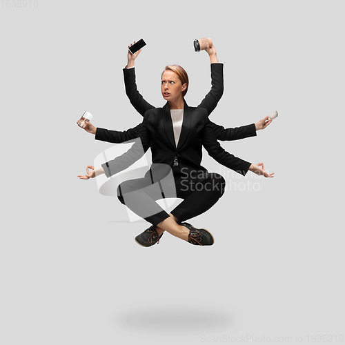 Image of Beautiful business woman, secretary, multi-armed manager levitating isolated on grey studio background