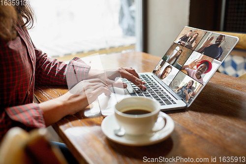 Image of Remote working. Workplace in bar, restaurant office with PC, devices and gadgets.