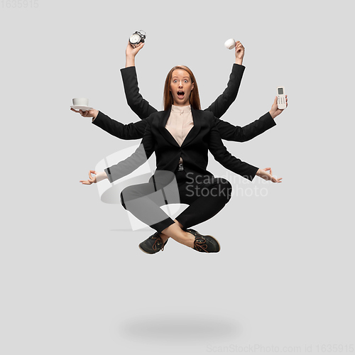 Image of Beautiful business woman, secretary, multi-armed manager levitating isolated on grey studio background