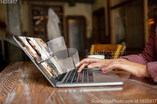 Image of Remote working. Workplace in bar, restaurant office with PC, devices and gadgets.