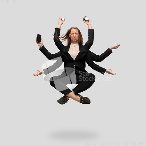 Image of Beautiful business woman, secretary, multi-armed manager levitating isolated on grey studio background