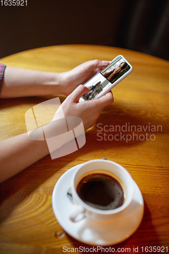 Image of Remote working. Workplace in bar, restaurant office with PC, devices and gadgets.