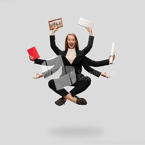 Image of Beautiful business woman, secretary, multi-armed manager levitating isolated on grey studio background