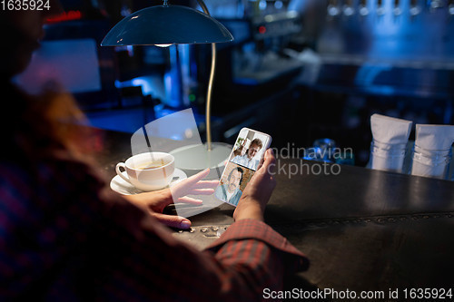 Image of Remote working. Workplace in bar, restaurant office with PC, devices and gadgets.