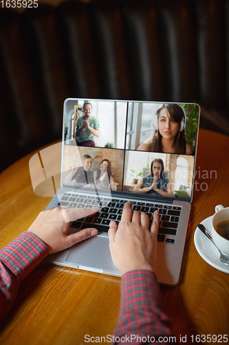 Image of Remote working. Workplace in bar, restaurant office with PC, devices and gadgets.