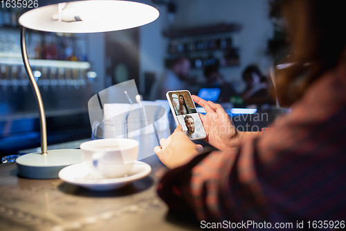 Image of Remote working. Workplace in bar, restaurant office with PC, devices and gadgets.