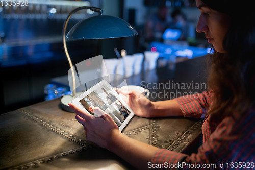 Image of Remote working. Workplace in bar, restaurant office with PC, devices and gadgets.