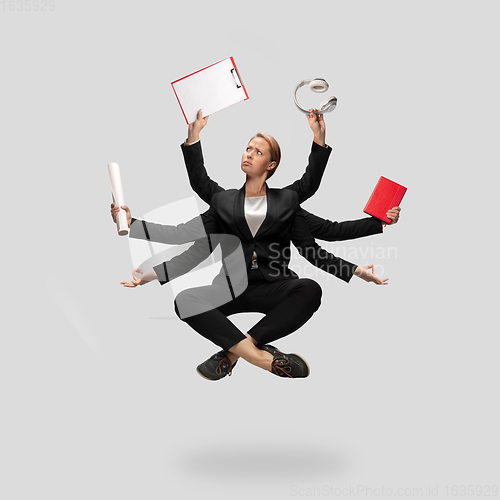 Image of Beautiful business woman, secretary, multi-armed manager levitating isolated on grey studio background