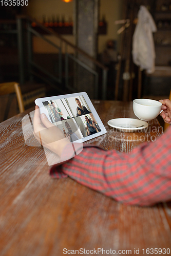 Image of Remote working. Workplace in bar, restaurant office with PC, devices and gadgets.