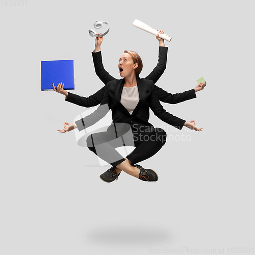 Image of Beautiful business woman, secretary, multi-armed manager levitating isolated on grey studio background