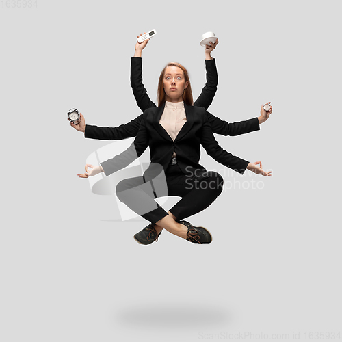 Image of Beautiful business woman, secretary, multi-armed manager levitating isolated on grey studio background